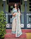 Ivory Cotton Linen Saree | Teal Border, Floral Print, Blouse & Tassel Edges – Buy Online