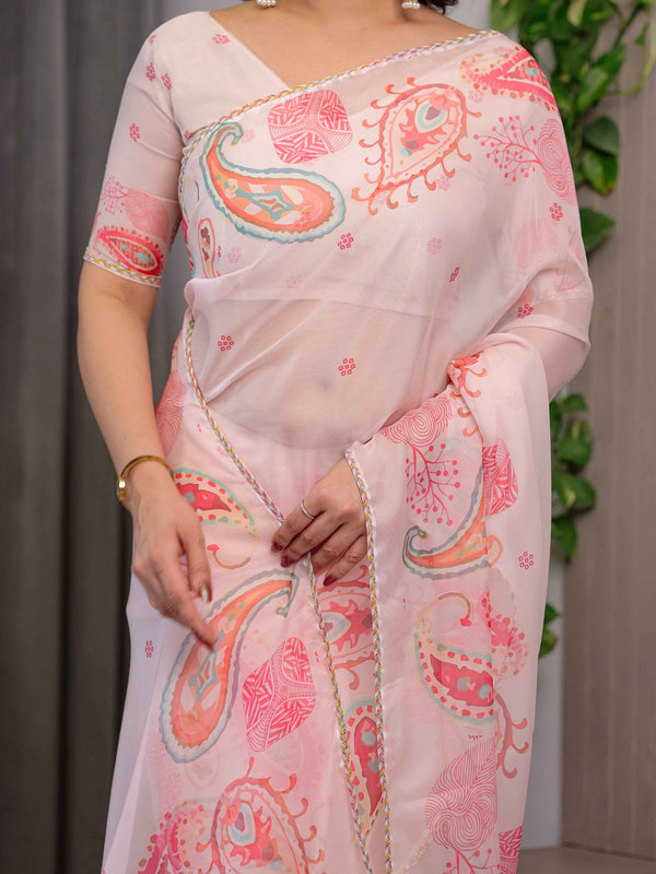 Pastel Peach Printed Organza Saree with Paisley Motifs & Multicolour Lace Border | Designer Lightweight Organza Saree with Attached Blouse Piece | Festive & Party Wear Saree