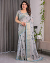 Ice Grey Handloom Linen Saree with Floral Print, Gold Zari Border & Tassel Detailing | Attached Blouse Piece | 5.5m Saree + 0.8m Blouse