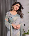 Ice Grey Handloom Linen Saree with Floral Print, Gold Zari Border & Tassel Detailing | Attached Blouse Piece | 5.5m Saree + 0.8m Blouse