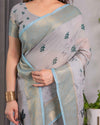 Ice Grey Handloom Linen Saree with Floral Print, Gold Zari Border & Tassel Detailing | Attached Blouse Piece | 5.5m Saree + 0.8m Blouse